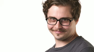 stock-footage-white-male-hipster-with-a-mustache-and-glasses-looks-into-the-camera-and-smiles-on-a-white